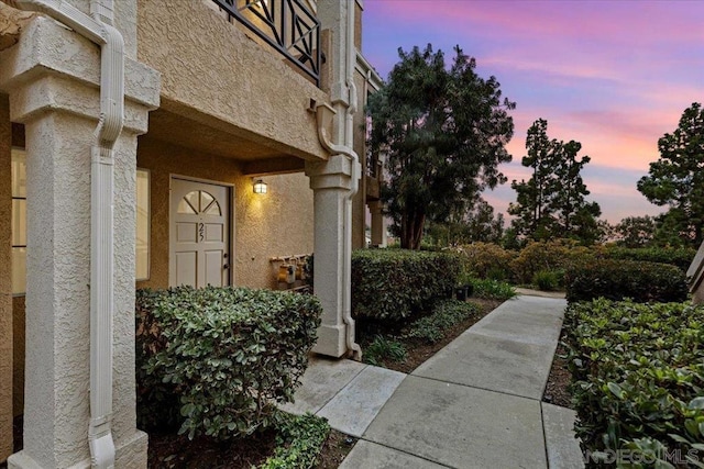 view of exterior entry at dusk