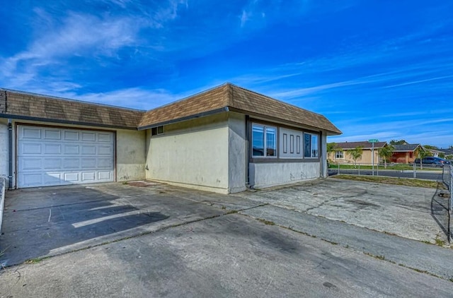 view of side of property with a garage