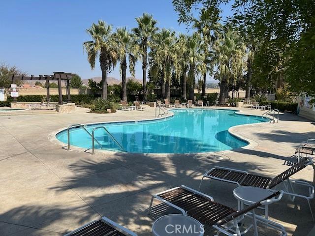 view of pool with a pergola and a patio