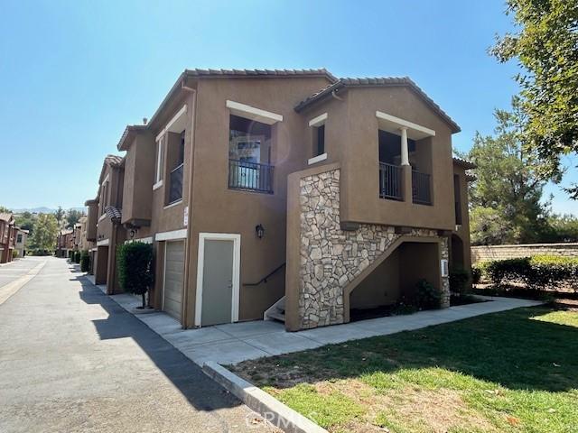 exterior space featuring a garage and a yard