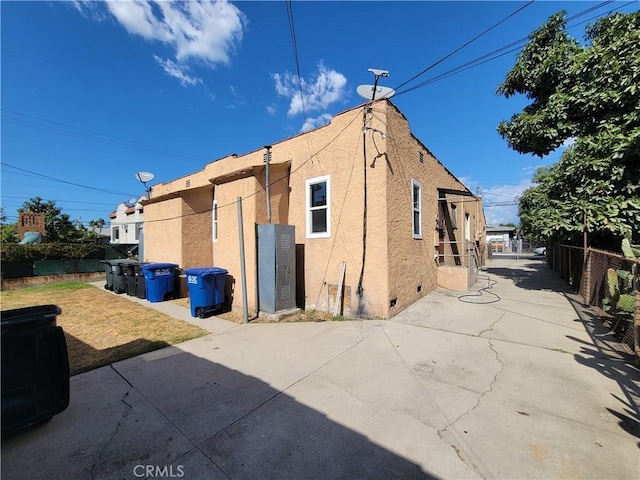 view of property exterior with a patio area