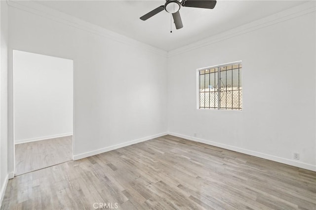 unfurnished room with ornamental molding, ceiling fan, and light wood-type flooring