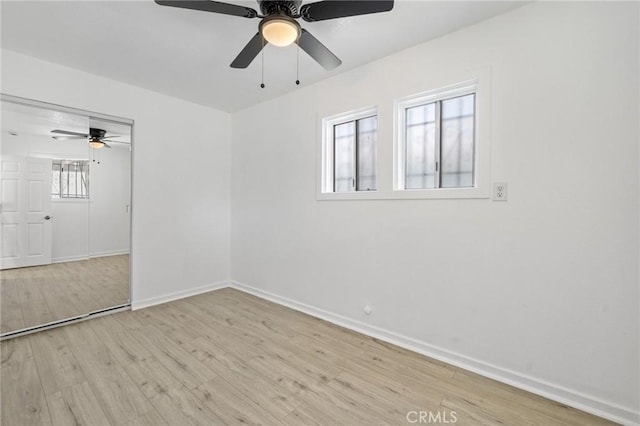 spare room featuring ceiling fan and light wood-type flooring