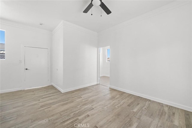 spare room with ceiling fan, light wood-type flooring, and crown molding