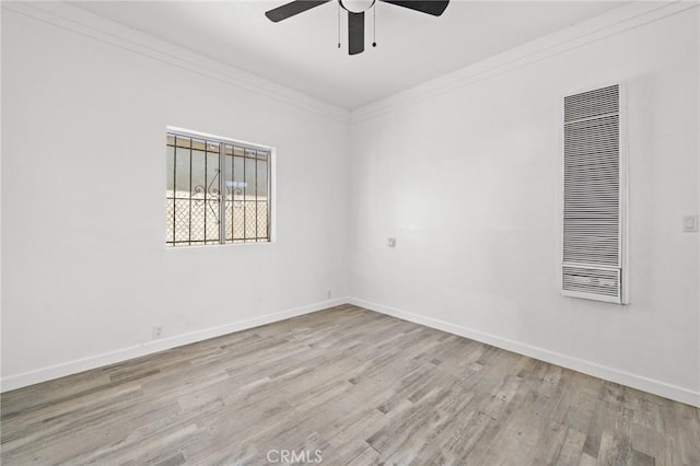 empty room with ceiling fan, ornamental molding, and light hardwood / wood-style floors