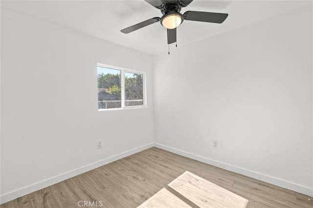 spare room with light wood-type flooring and ceiling fan