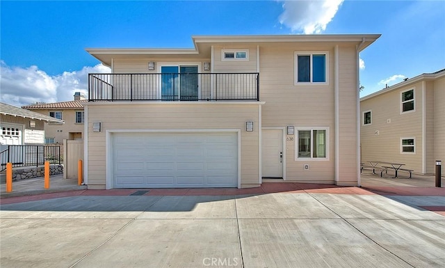 view of front of house featuring a balcony and a garage