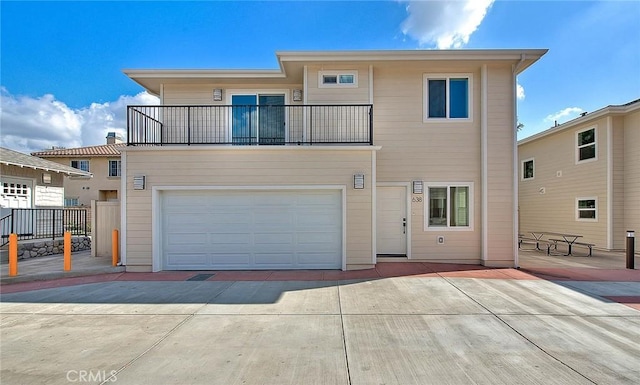 view of front facade featuring a garage and a balcony