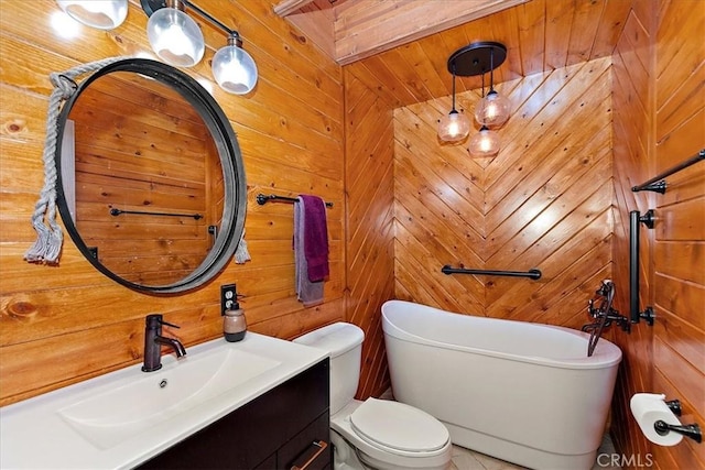 bathroom with wooden walls, a bathtub, vanity, and toilet