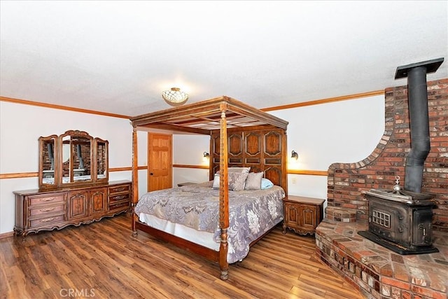 bedroom with hardwood / wood-style flooring and crown molding