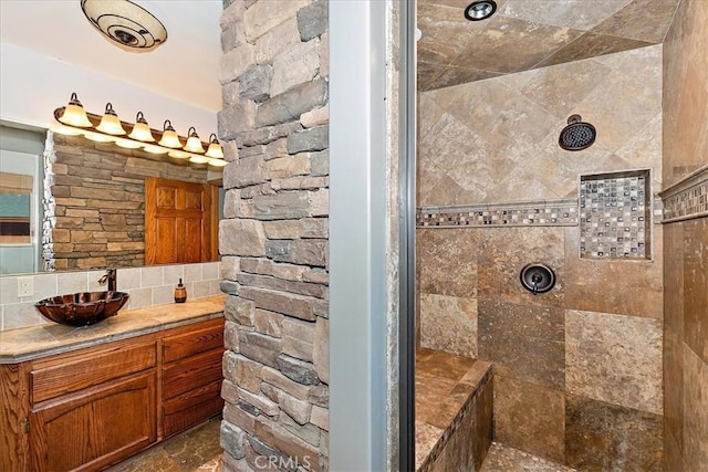 bathroom with vanity and tiled shower