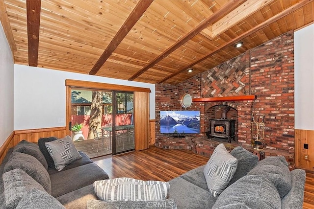 living room featuring wood-type flooring, vaulted ceiling with beams, a wood stove, and wood ceiling