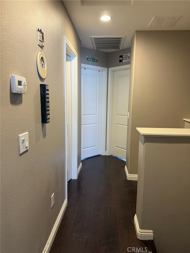 hallway with dark hardwood / wood-style flooring