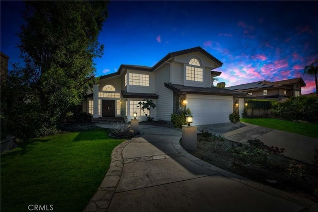 front facade with a lawn and a garage