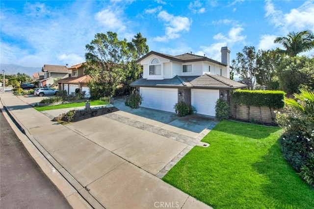 front of property featuring a front yard and a garage