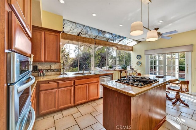 kitchen featuring decorative backsplash, stainless steel appliances, a healthy amount of sunlight, and sink