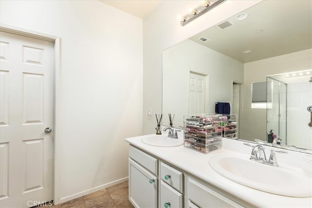 bathroom featuring tile patterned flooring, vanity, and a shower with door