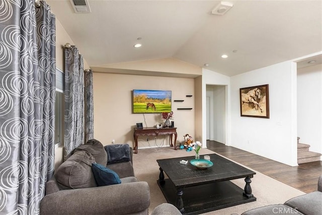 living room featuring dark hardwood / wood-style flooring and vaulted ceiling