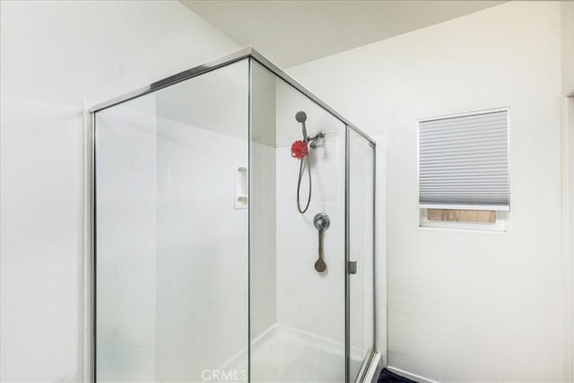 bathroom with a shower with shower door