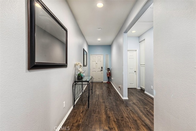 corridor featuring dark hardwood / wood-style floors