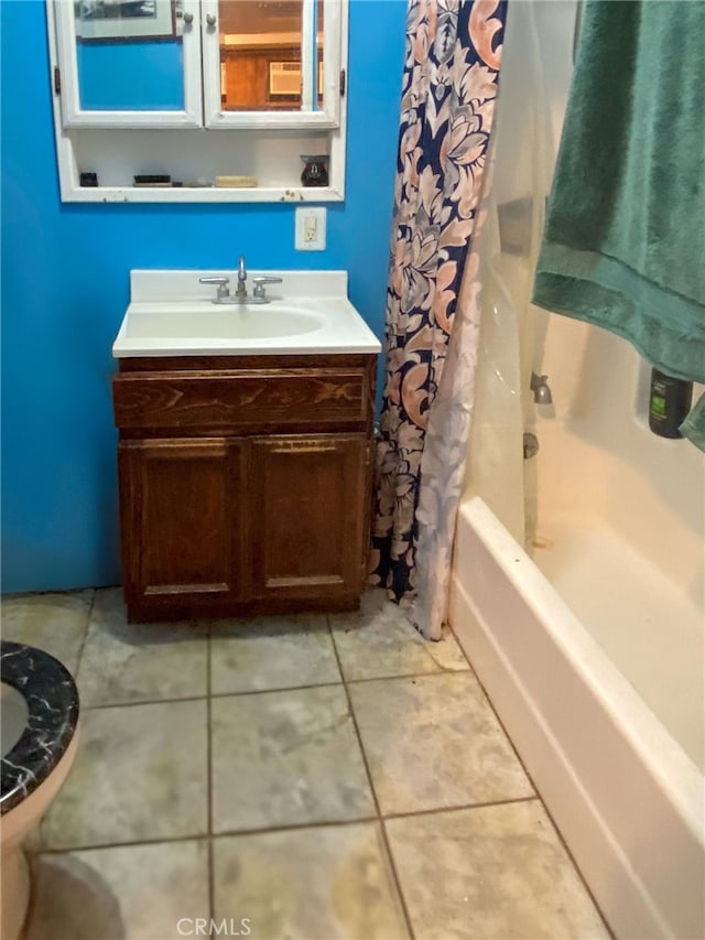 bathroom featuring tile patterned floors, vanity, and shower / bath combo