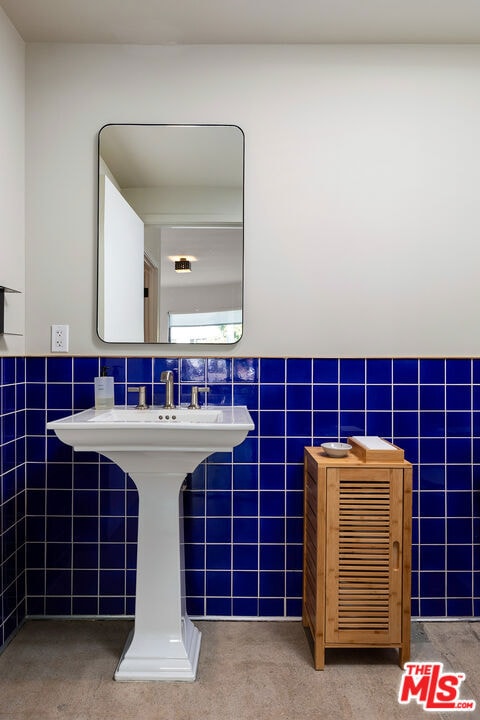 bathroom with tile walls