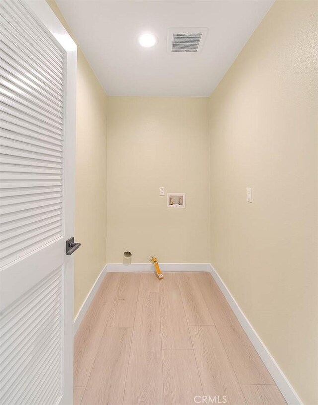 laundry room featuring hookup for a gas dryer, light hardwood / wood-style floors, and hookup for a washing machine