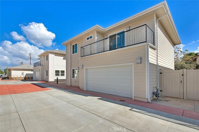 view of front of home with a garage and a balcony