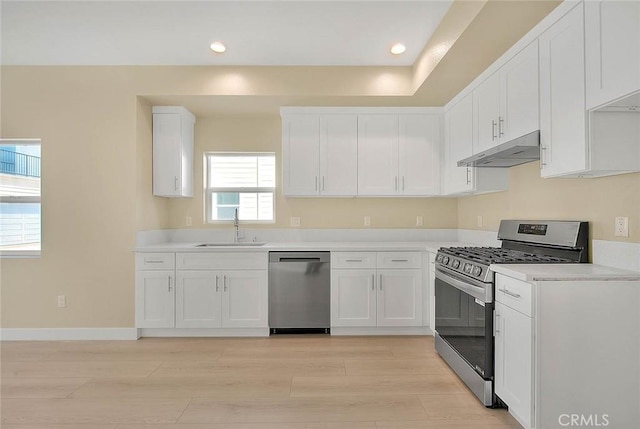 kitchen featuring sink, white cabinets, light wood-type flooring, and appliances with stainless steel finishes