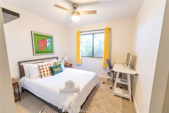 bedroom with ceiling fan and light carpet