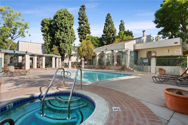 view of swimming pool with a community hot tub and a patio