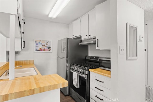 kitchen featuring white cabinets, dark hardwood / wood-style flooring, sink, and appliances with stainless steel finishes