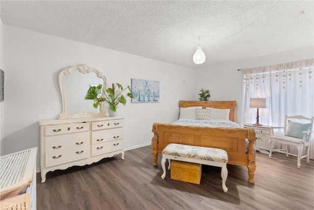 bedroom featuring a textured ceiling and dark wood-type flooring