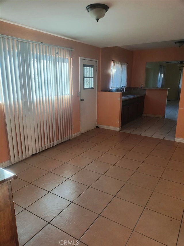 kitchen with light tile patterned floors and sink