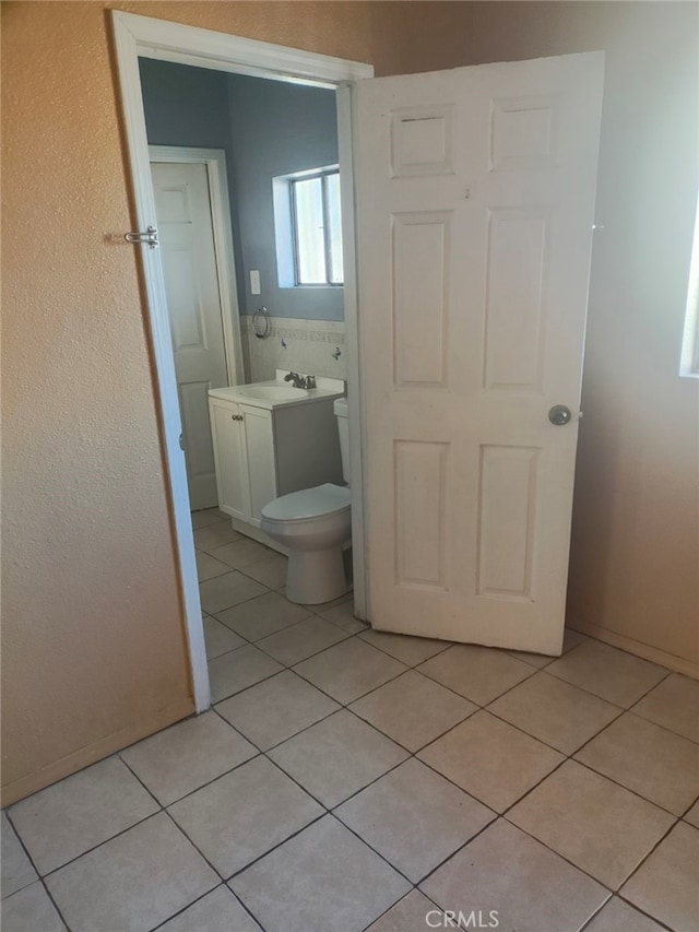 bathroom featuring tile patterned floors, toilet, and sink