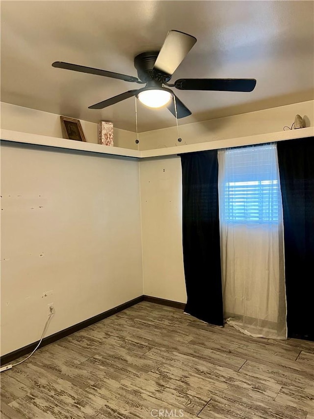 empty room with wood-type flooring and ceiling fan