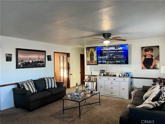 living room featuring ceiling fan, carpet, and a textured ceiling