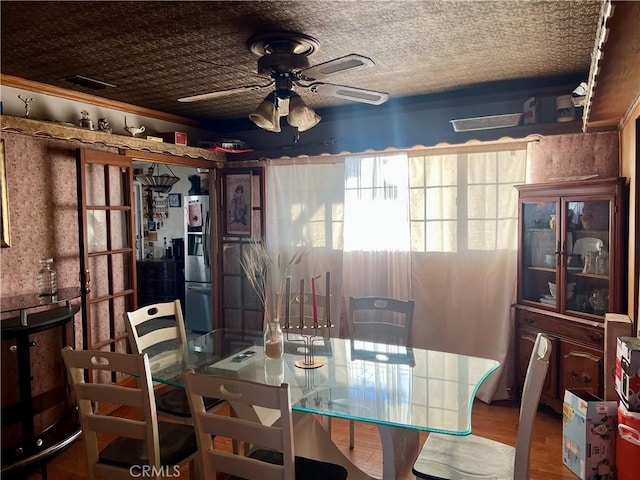 dining space with ceiling fan and hardwood / wood-style flooring