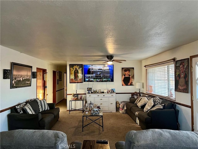 carpeted living room with ceiling fan and a textured ceiling