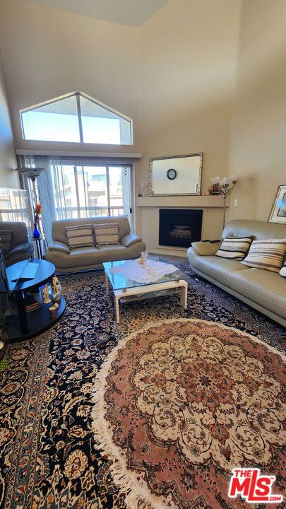 living room featuring carpet floors and a high ceiling