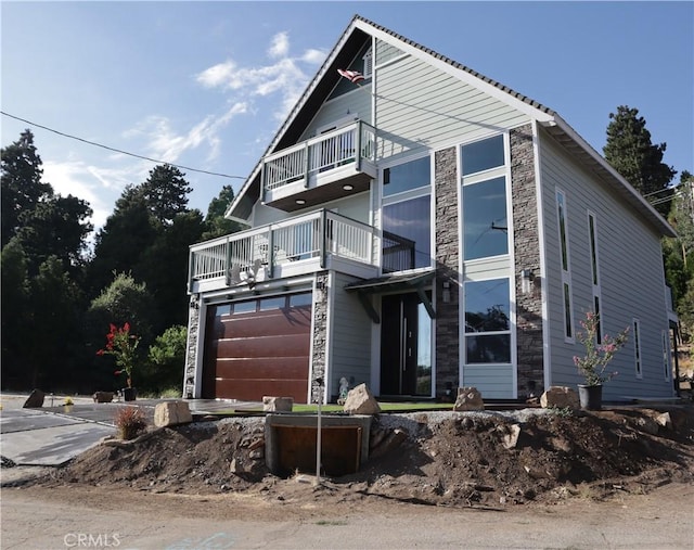 view of front facade featuring a garage and a balcony