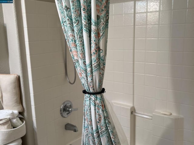 bathroom with shower / bath combo with shower curtain