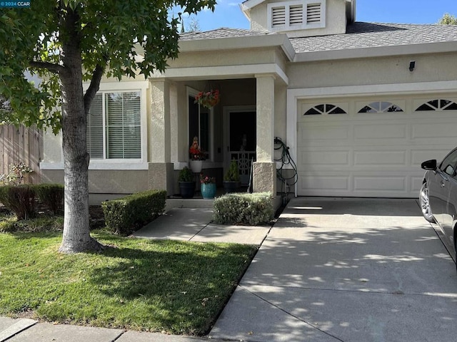 view of front of property featuring a garage and a front lawn