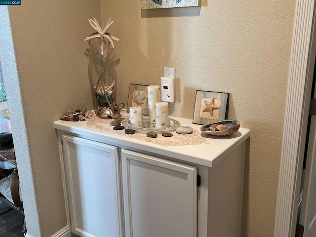 bar featuring white cabinets