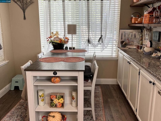 dining area with dark hardwood / wood-style floors