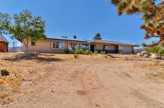 ranch-style home with solar panels and a garage