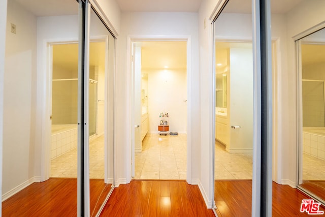 hallway with wood-type flooring