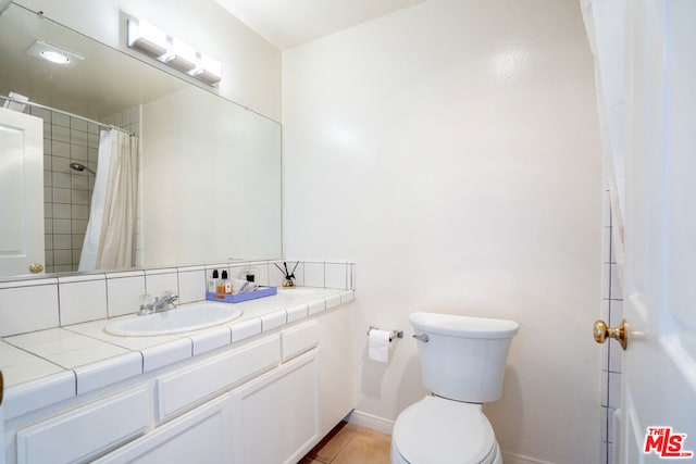 bathroom with tile patterned floors, vanity, and toilet