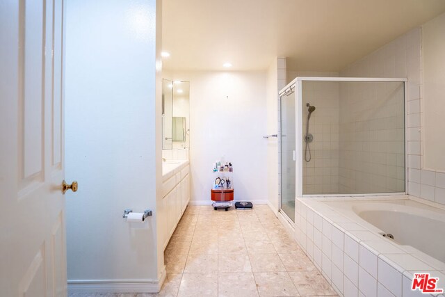 bathroom with shower with separate bathtub, vanity, and tile patterned floors