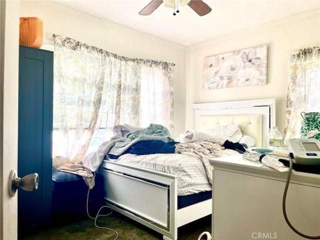 bedroom with multiple windows, ornamental molding, and ceiling fan